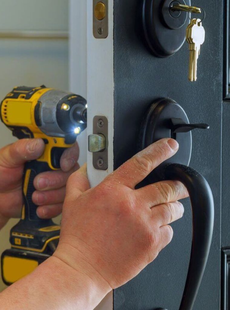 closeup-of-a-professional-locksmith-installing-a-new-lock-on-a-house-exterior-door-from-inside